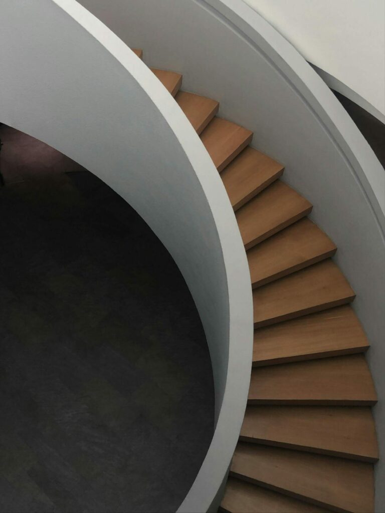 Brown Wooden Spiral Staircase in High Angle Shot